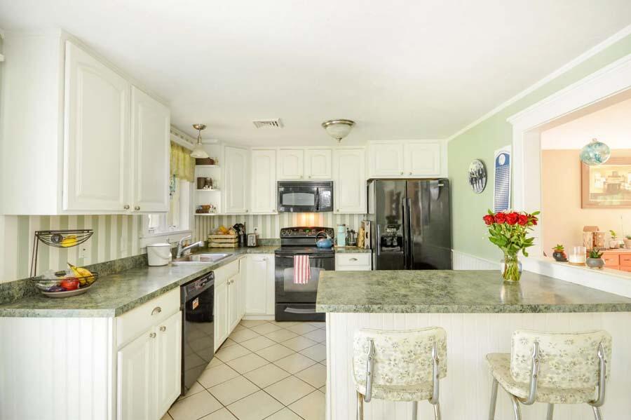 10 Meredith Road Forestdale, MA 02644 - Photo 6 of 29 a kitchen with granite countertop stainless steel appliances a sink dishwasher a refrigerator and cabinets