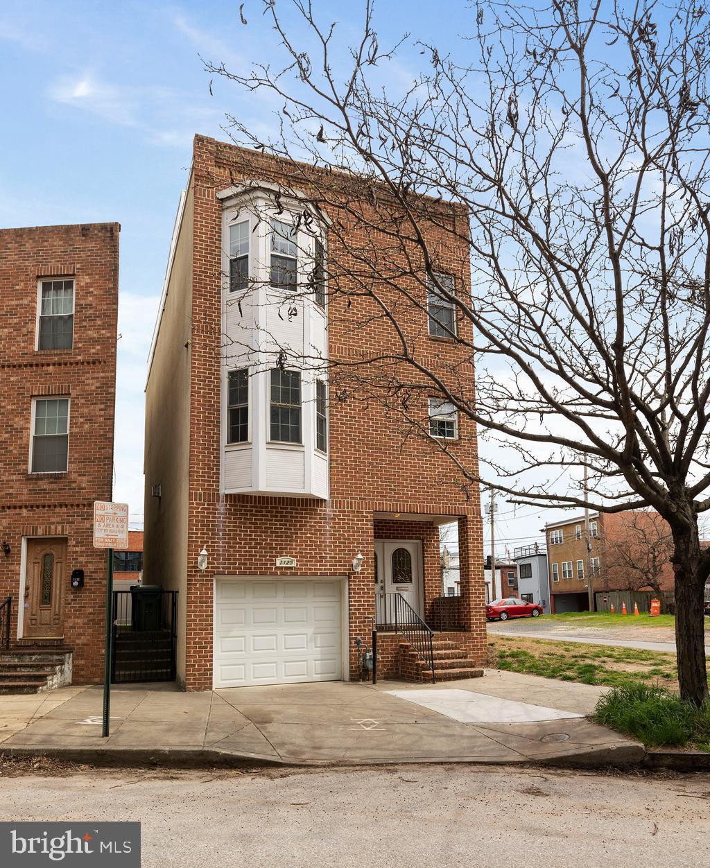1125 Race Street Baltimore, MD 21230 - Photo 2 of 43 a front view of a house with a garden