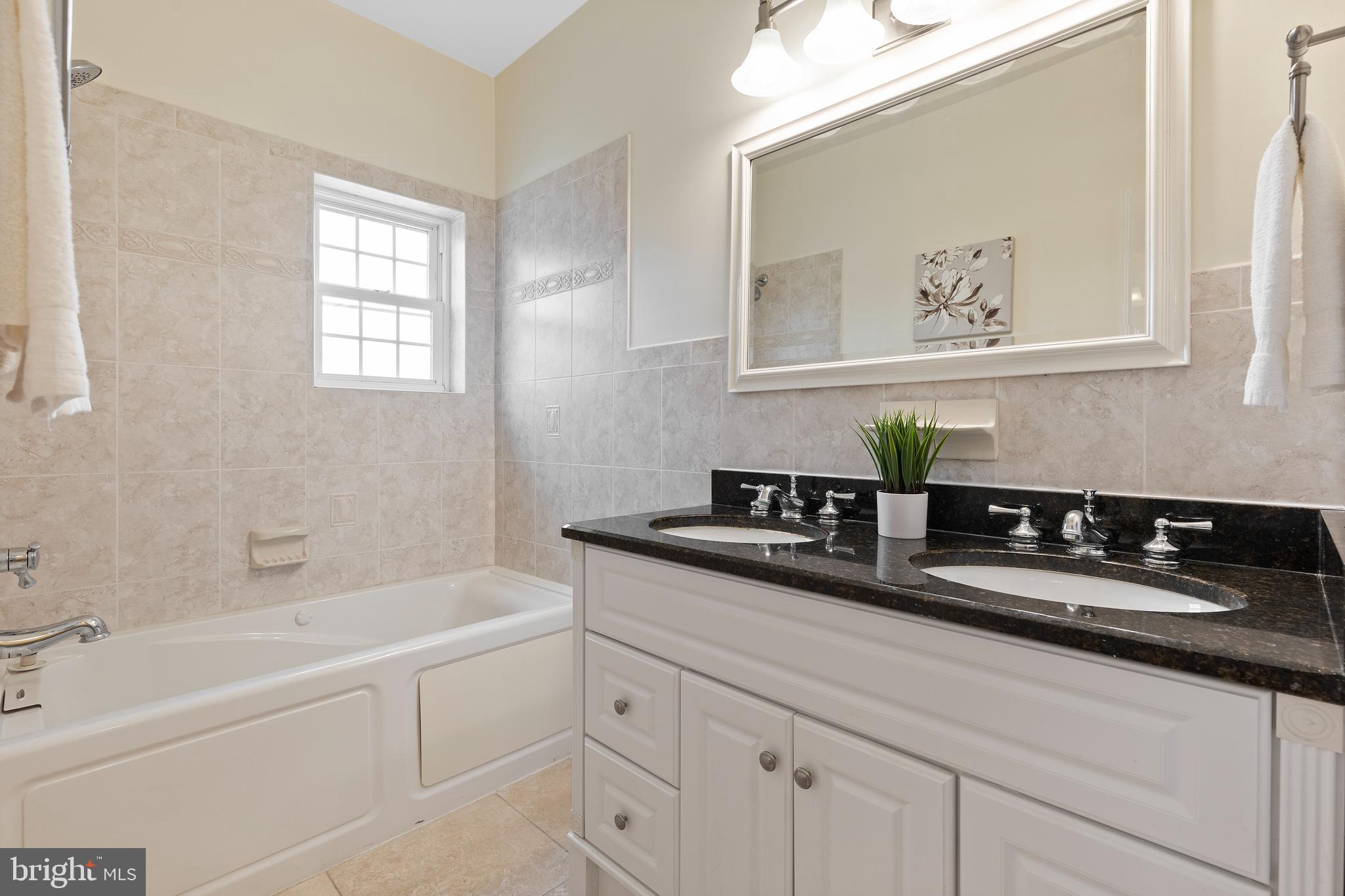 1125 Race Street Baltimore, MD 21230 - Photo 22 of 43 a bath room with a sink and a mirror