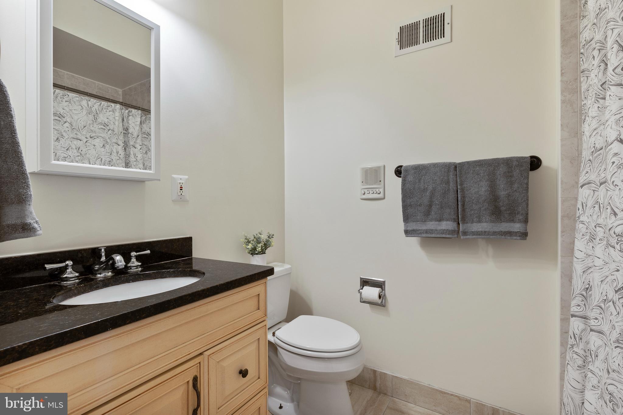 1125 Race Street Baltimore, MD 21230 - Photo 26 of 43 a bathroom with a toilet a sink and a window