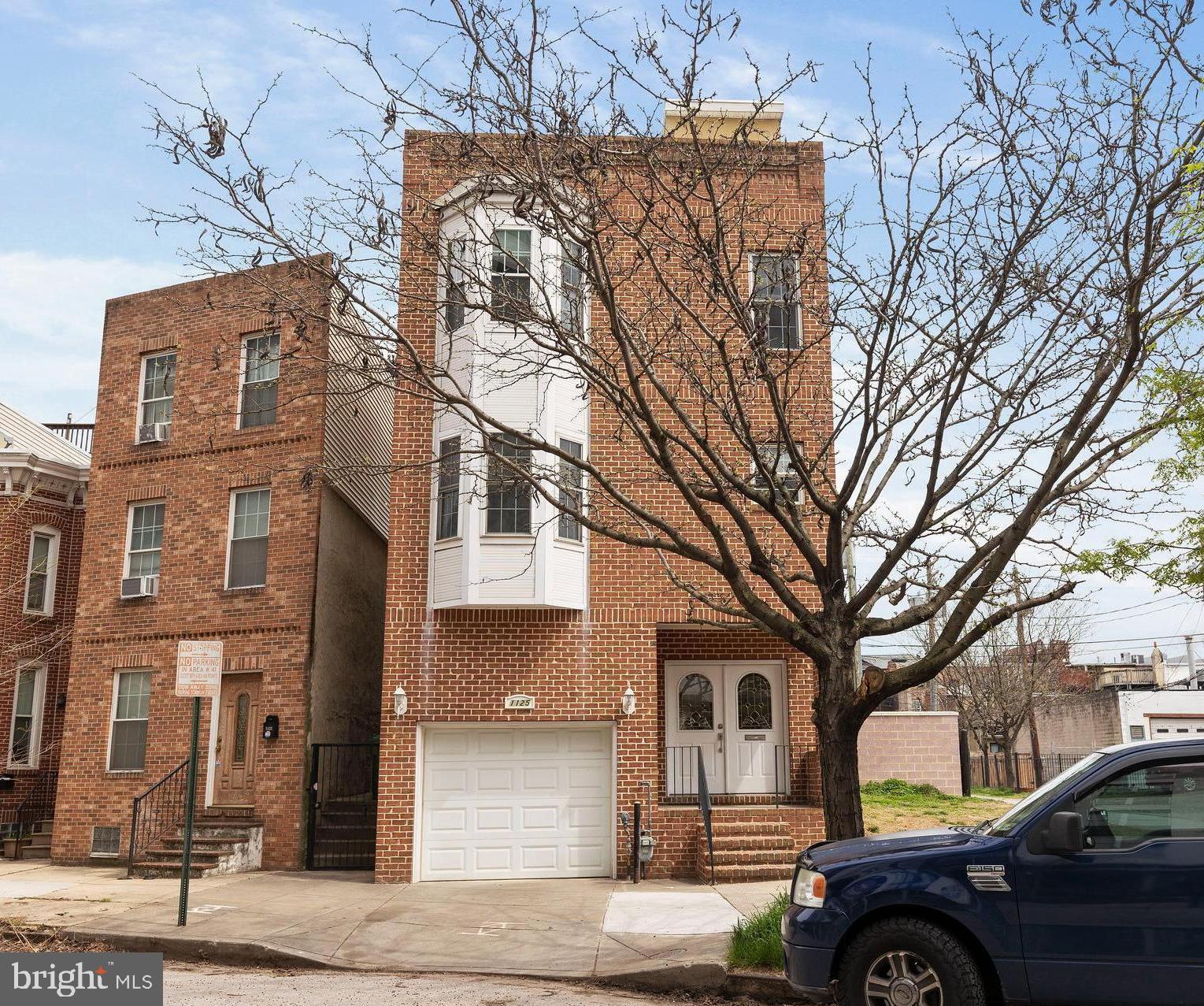 1125 Race Street Baltimore, MD 21230 - Photo 3 of 43 a front view of a house with parking area