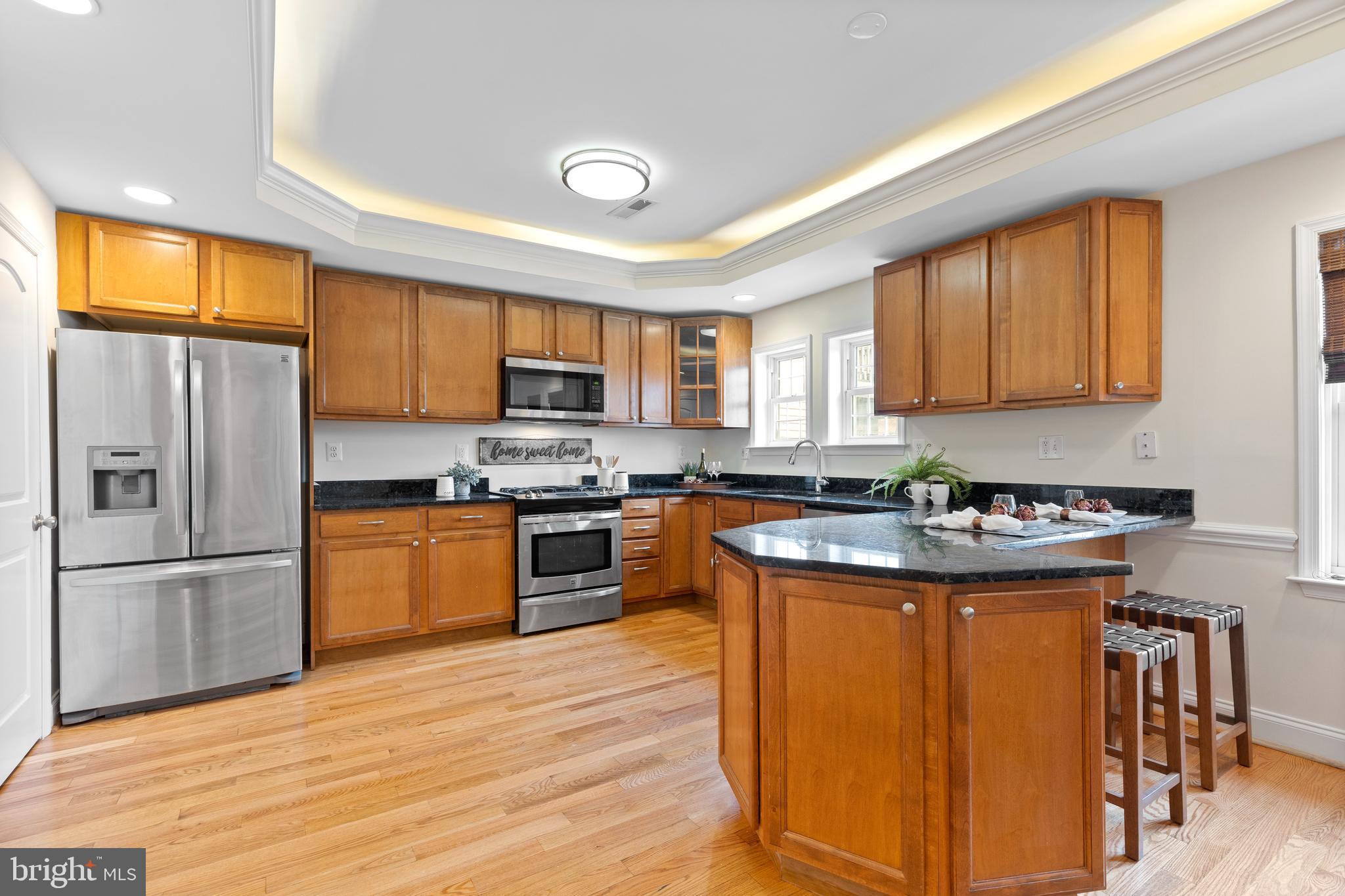 1125 Race Street Baltimore, MD 21230 - Photo 5 of 43 a kitchen with stainless steel appliances granite countertop a stove top oven a sink dishwasher a refrigerator and a microwave oven on the wooden floor