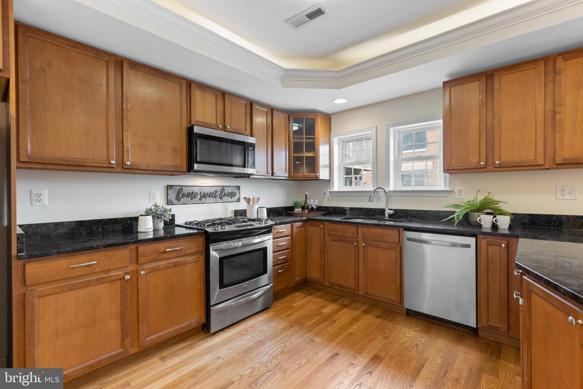1125 Race Street Baltimore, MD 21230 - Photo 6 of 43 a kitchen with granite countertop wooden cabinets and a stove top oven