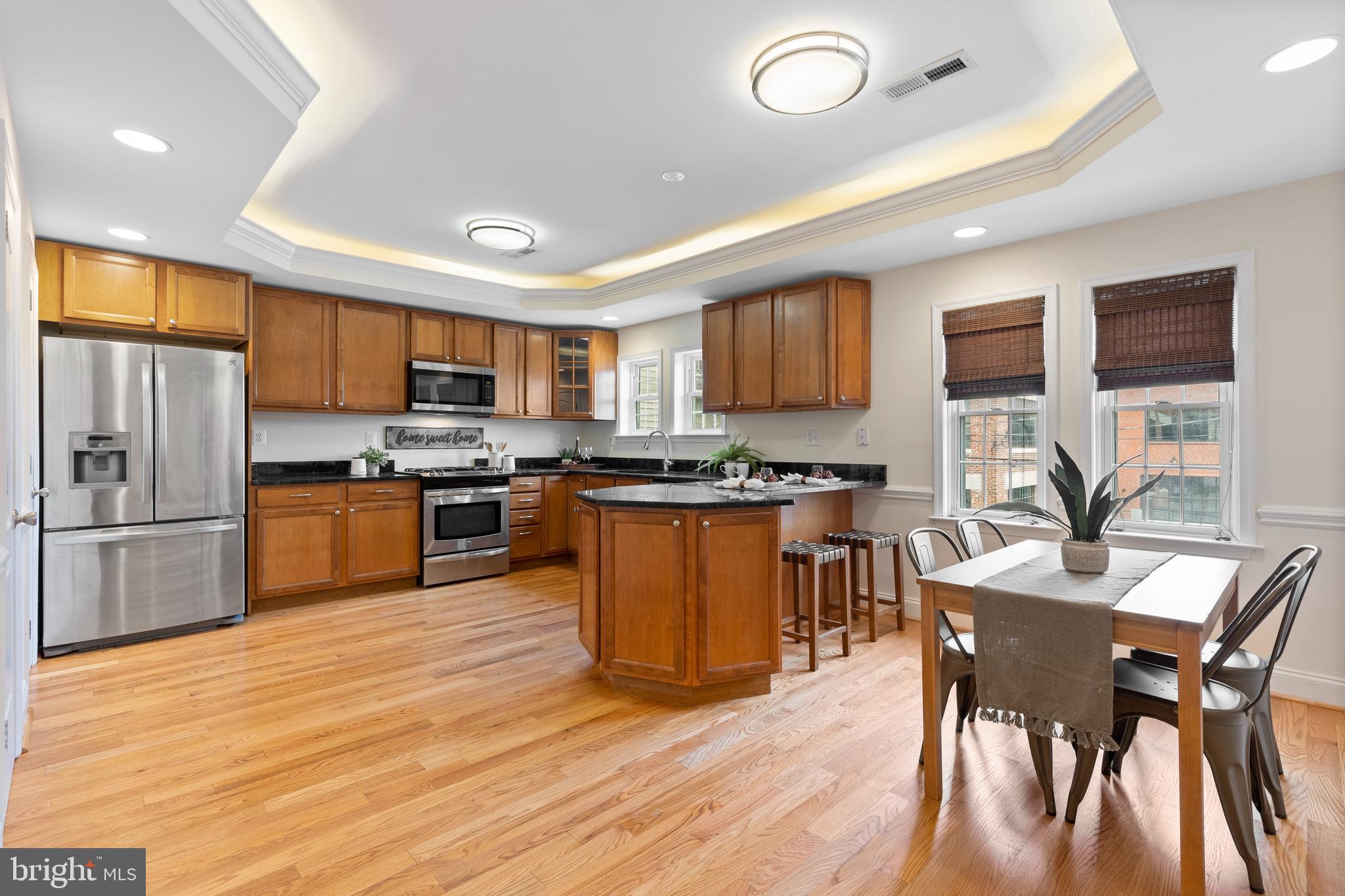 1125 Race Street Baltimore, MD 21230 - Photo 9 of 43 a kitchen with stainless steel appliances wooden floors and wooden cabinets