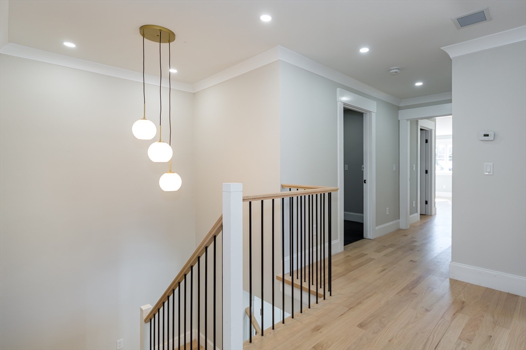 57 Beverly Road Natick, MA 01760 - Photo 12 of 20 a view of a hallway with wooden floor
