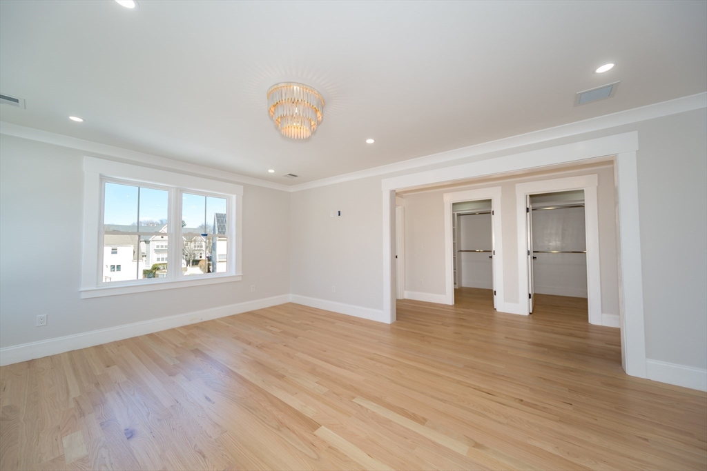 57 Beverly Road Natick, MA 01760 - Photo 13 of 20 an empty room with wooden floor and windows