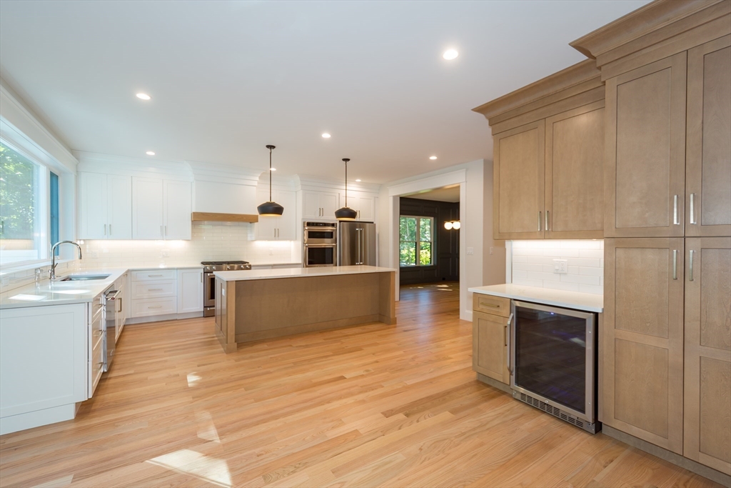 57 Beverly Road Natick, MA 01760 - Photo 3 of 20 a large kitchen with stainless steel appliances kitchen island granite countertop a large counter top and a stove top oven