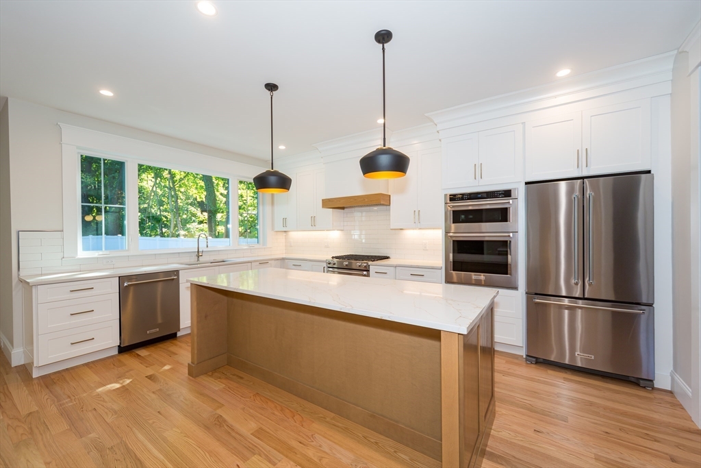 57 Beverly Road Natick, MA 01760 - Photo 4 of 20 a kitchen with appliances cabinets and a wooden floor