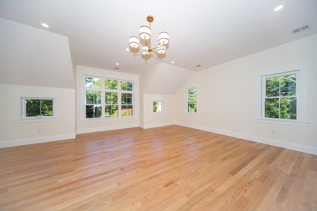 57 Beverly Road Natick, MA 01760 - Photo 6 of 20 a view of an empty room with wooden floor and a window