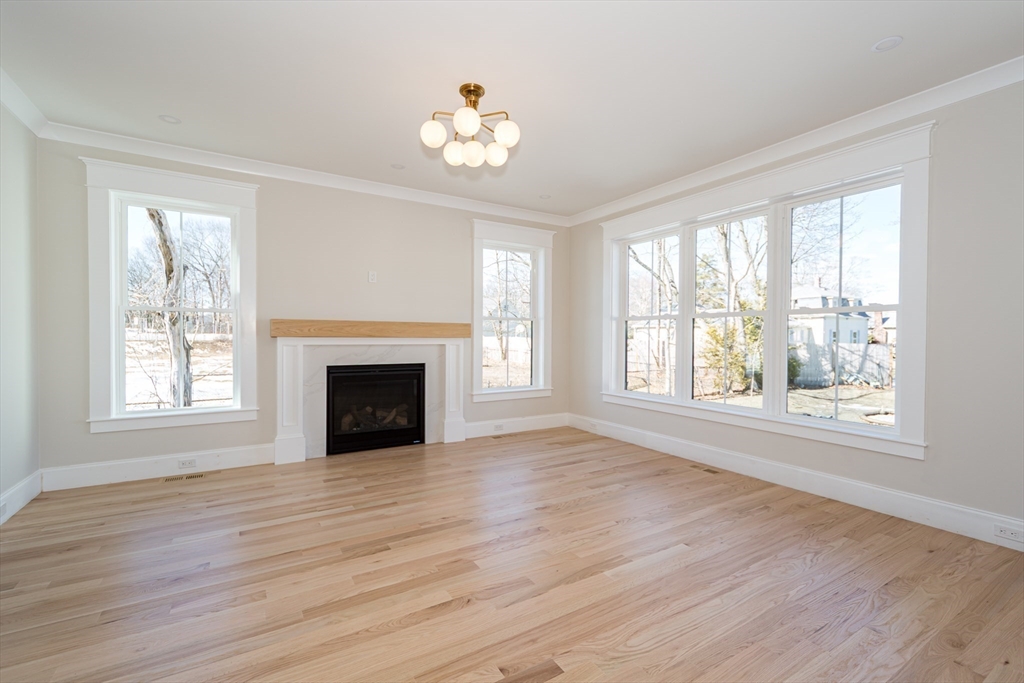 57 Beverly Road Natick, MA 01760 - Photo 9 of 20 a view of an empty room with wooden floor and a window