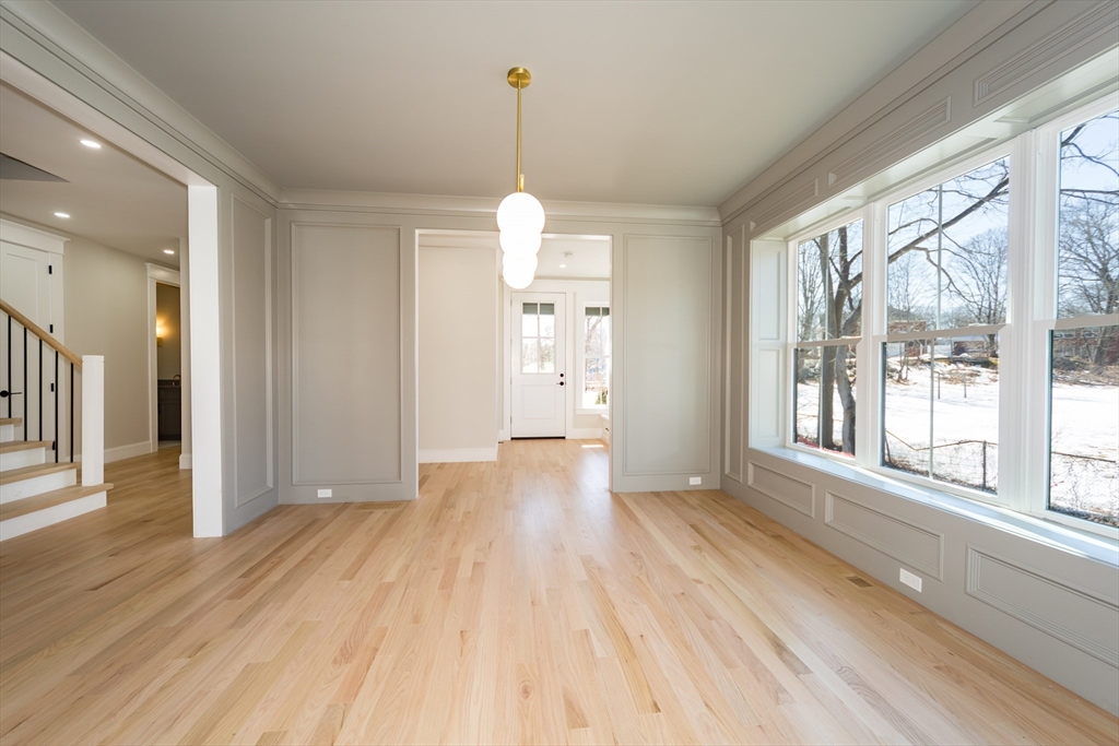 57 Beverly Road Natick, MA 01760 - Photo 10 of 20 a view of an empty room with wooden floor and a window