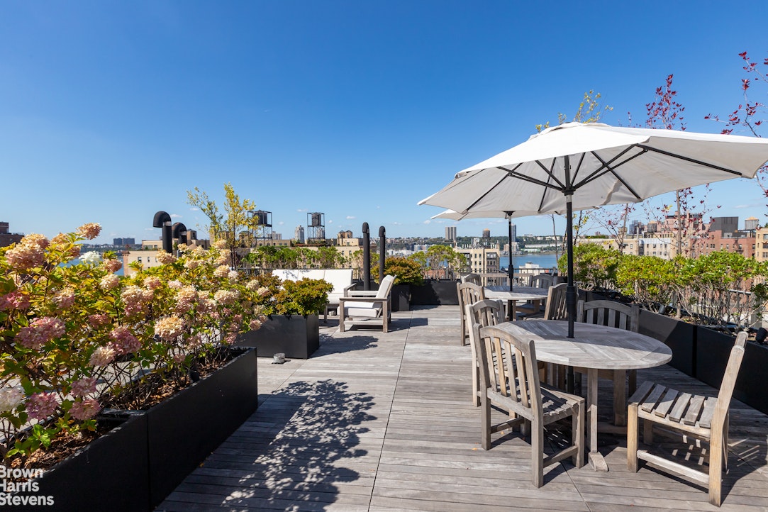 505 West End Avenue, Unit 4D Manhattan, NY 10024 - Photo 11 of 17 a view of a dining tables and chairs under an umbrella in the patio
