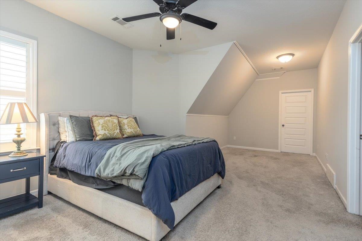 608 Cypress Run Cove Collierville, TN 38017 - Photo 27 of 40 Bedroom featuring a ceiling fan, light colored carpet, and vaulted ceiling
