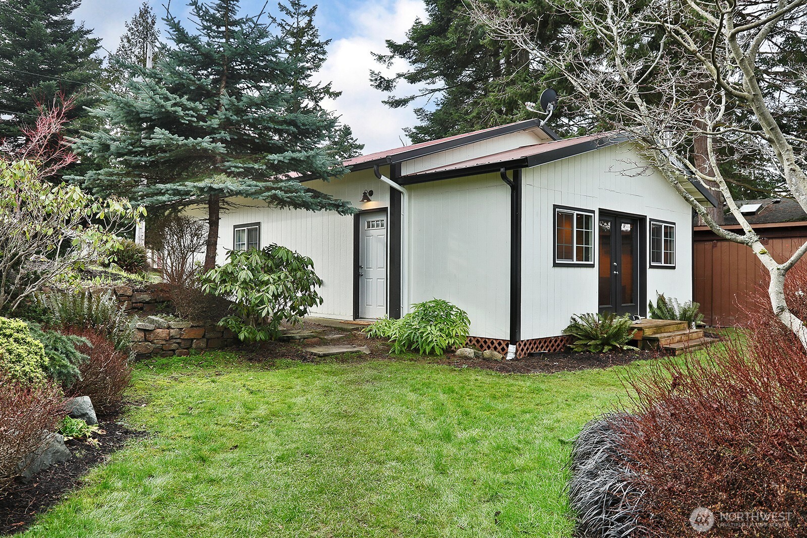 2999 Saratoga Road Langley, WA 98260 - Photo 34 of 40 a view of a house with a yard and plants