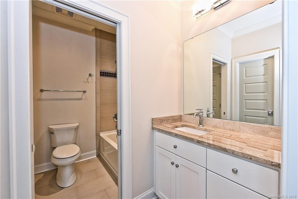 2308 Vernon Drive Charlotte, NC 28211 - Photo 18 of 24 a bathroom with a granite countertop toilet a sink and a mirror