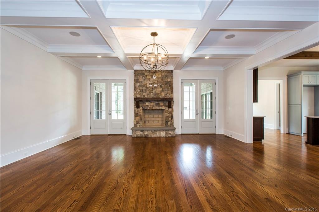 2308 Vernon Drive Charlotte, NC 28211 - Photo 9 of 24 a view of an empty room with wooden floor and a fireplace