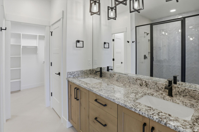 1315 West 3200 South, Unit 17 Perry, UT 84302 - Photo 32 of 58 Bathroom featuring a double vanity with stone countertops, rectangular undermount sinks, and matte black fixtures