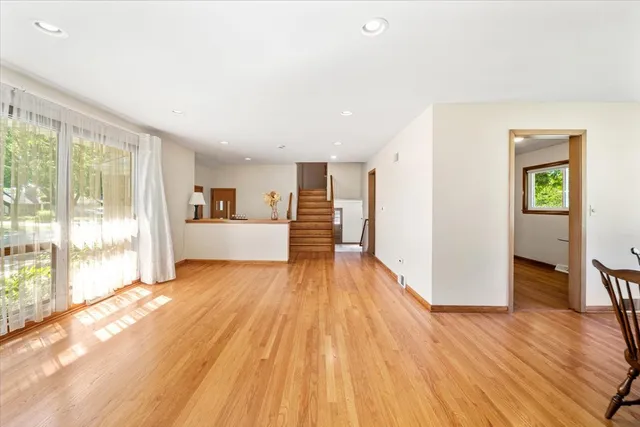 a view of a living room hardwood floor and a kitchen