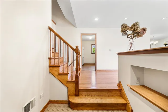 a view of entryway and hall with wooden floor