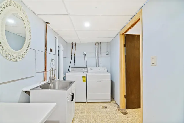 a view of a swimming pool with a table and chairs under an umbrella