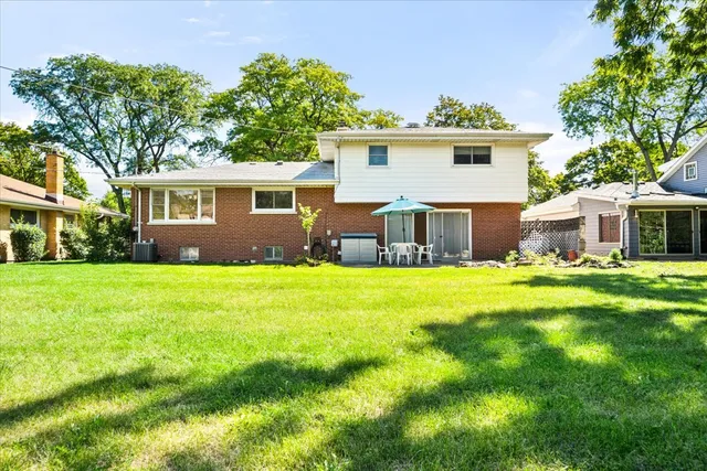 an aerial view of a house with yard swimming pool and outdoor seating