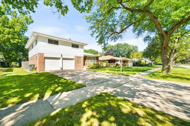 a view of a house with a tree and a yard