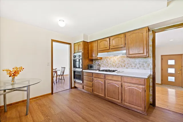 a kitchen with stainless steel appliances granite countertop a stove a sink and a refrigerator