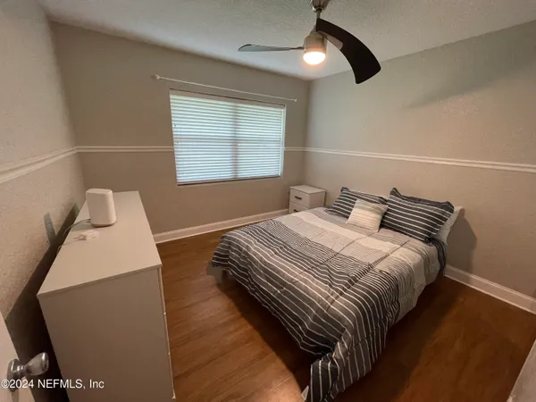 a bedroom with bed and a window