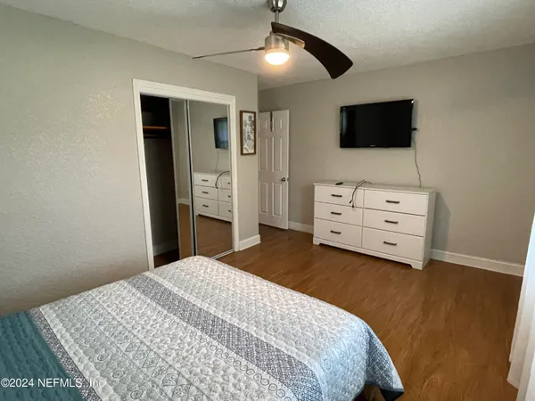 a bedroom with a bed and flat screen tv