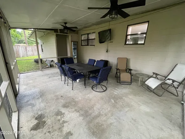 a view of a porch with chairs and backyard