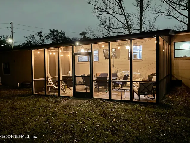 a backyard of a house with table and chairs
