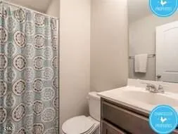a bathroom with a sink toilet and a mirror