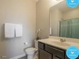 a bathroom with a sink toilet and a mirror