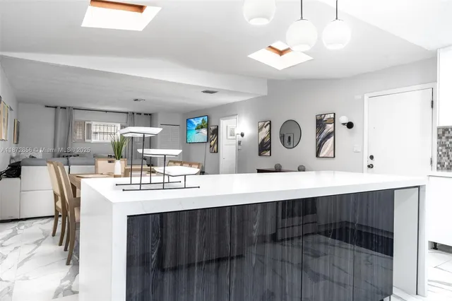 a kitchen with kitchen island a sink appliances and cabinets