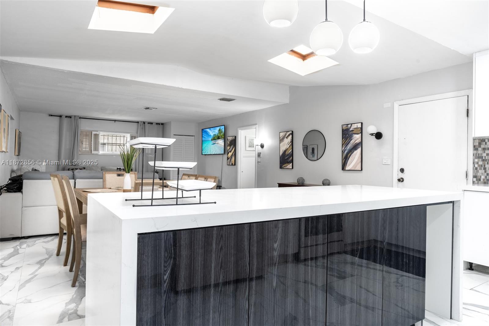 18525 Northwest 39th Avenue Miami Gardens, FL 33055 - Photo 5 of 11 a kitchen with kitchen island a sink appliances and cabinets