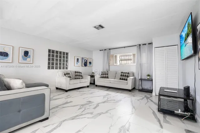 a spacious bedroom with a bed and a couch