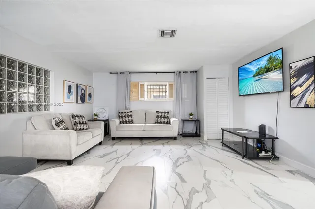 a living room with furniture and a window