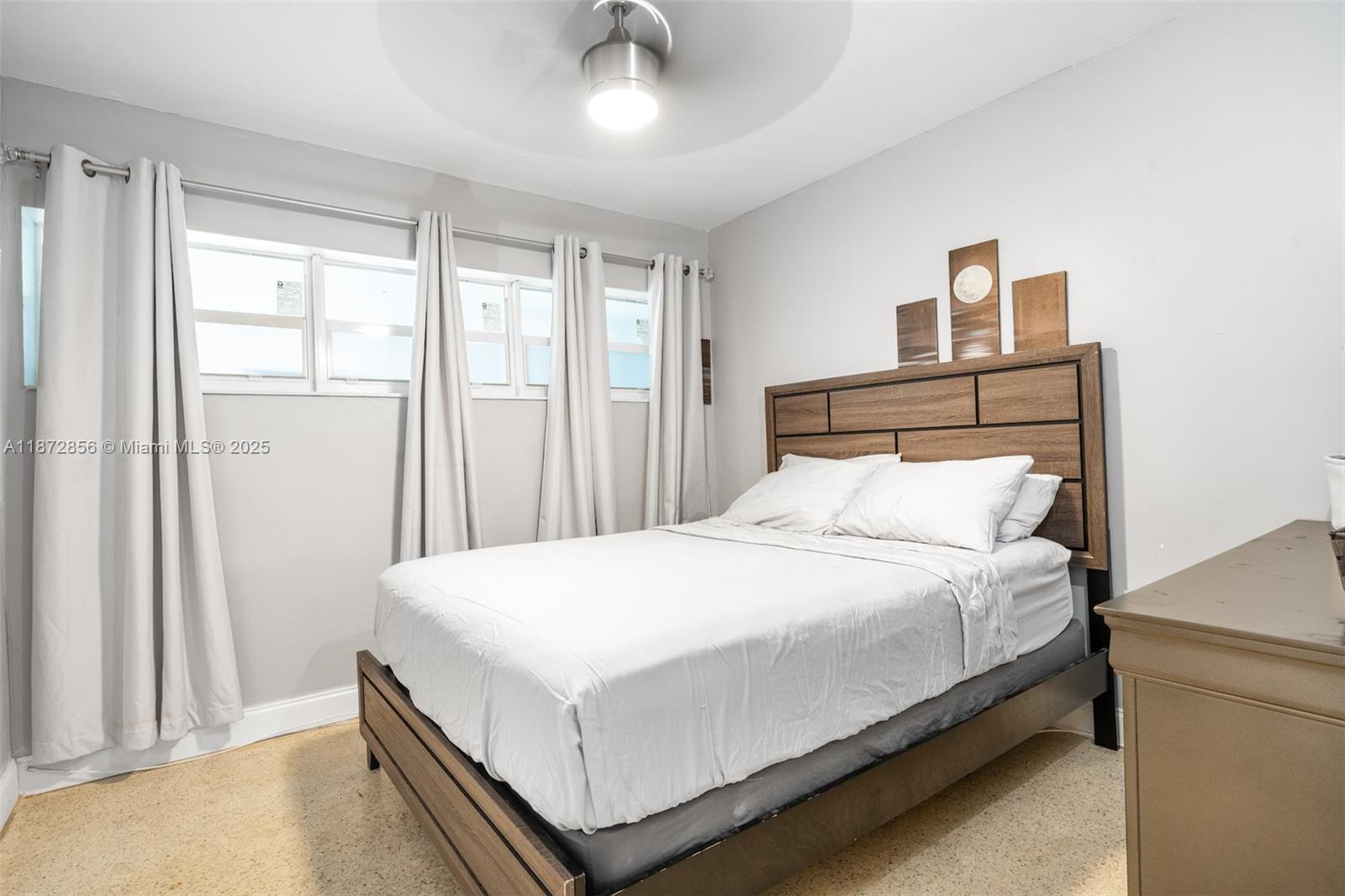 18525 Northwest 39th Avenue Miami Gardens, FL 33055 - Photo 10 of 11 a bedroom with a bed and a window