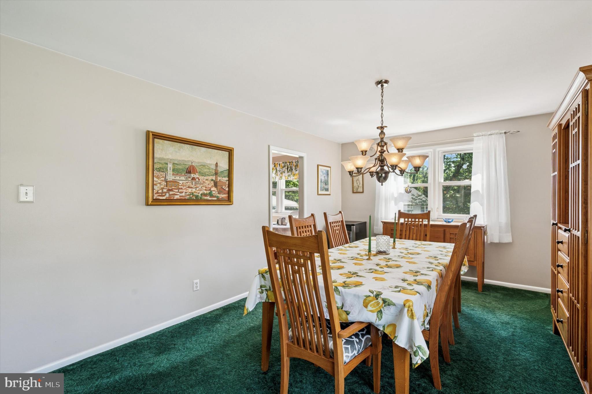 1007 Glen Road Wallingford, PA 19086 - Photo 13 of 50 a dining room with furniture a chandelier and a rug