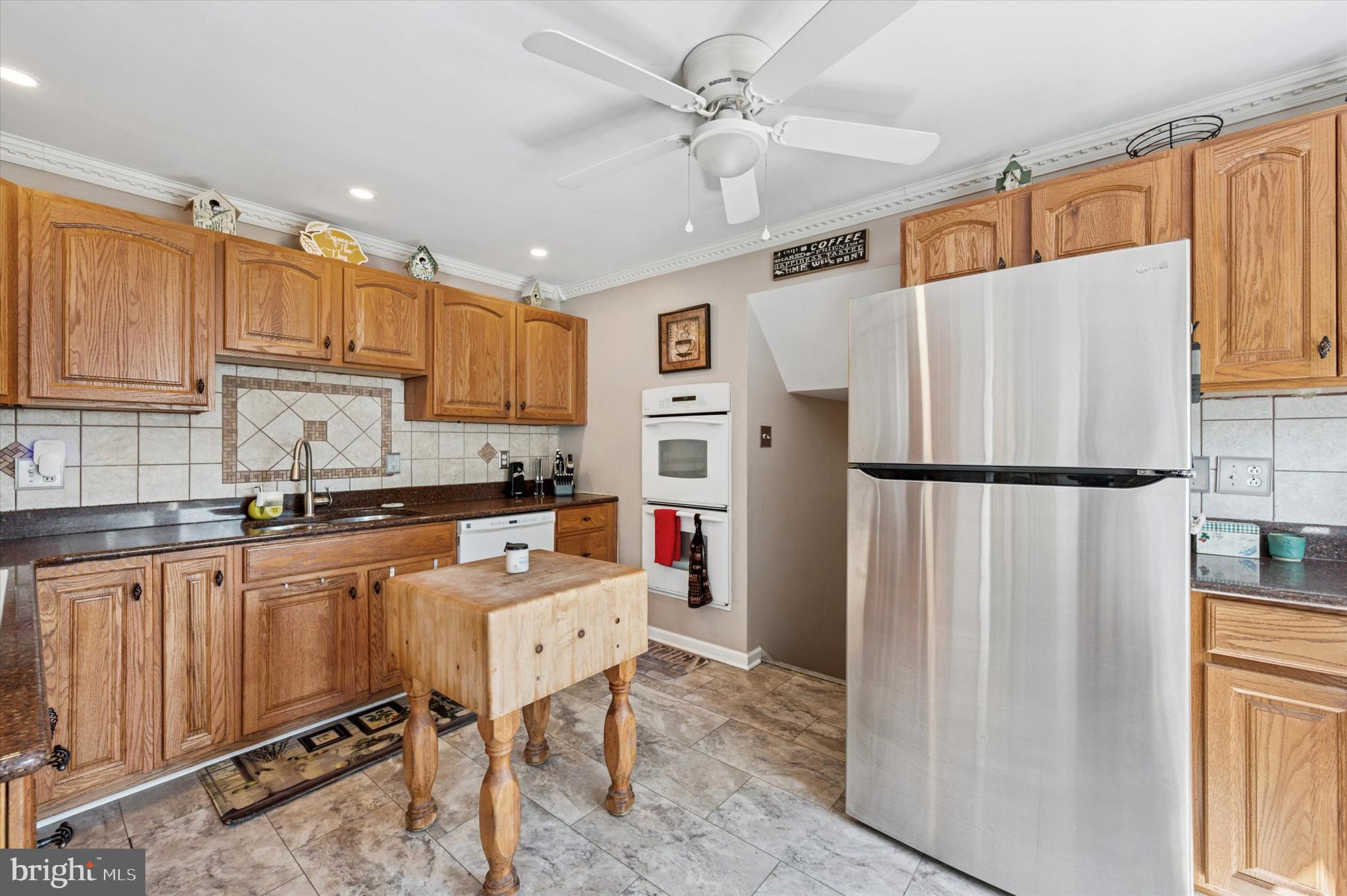 1007 Glen Road Wallingford, PA 19086 - Photo 16 of 50 a kitchen with stainless steel appliances granite countertop a refrigerator sink and cabinets
