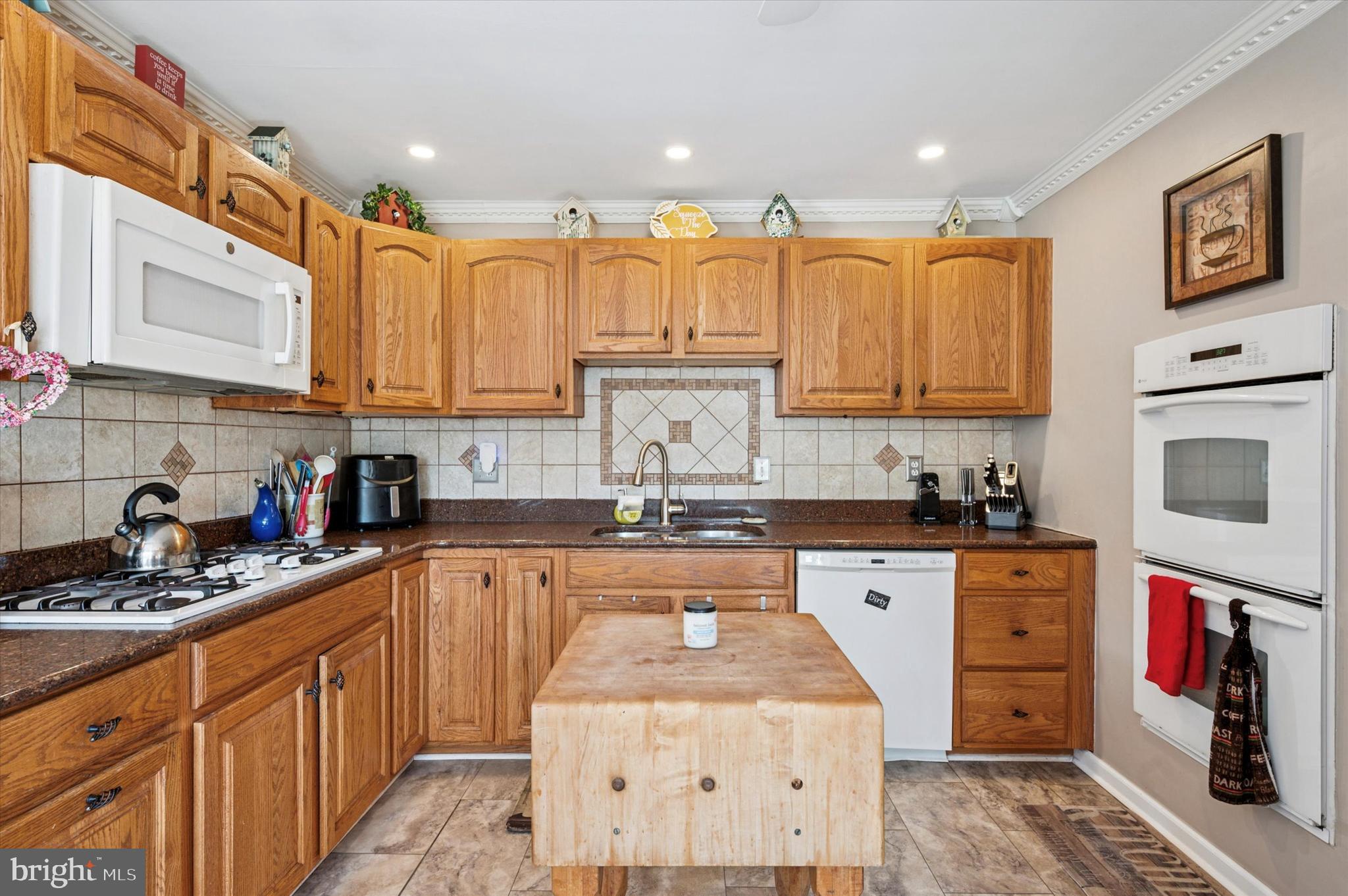1007 Glen Road Wallingford, PA 19086 - Photo 18 of 50 a kitchen with stainless steel appliances granite countertop a stove sink and cabinets
