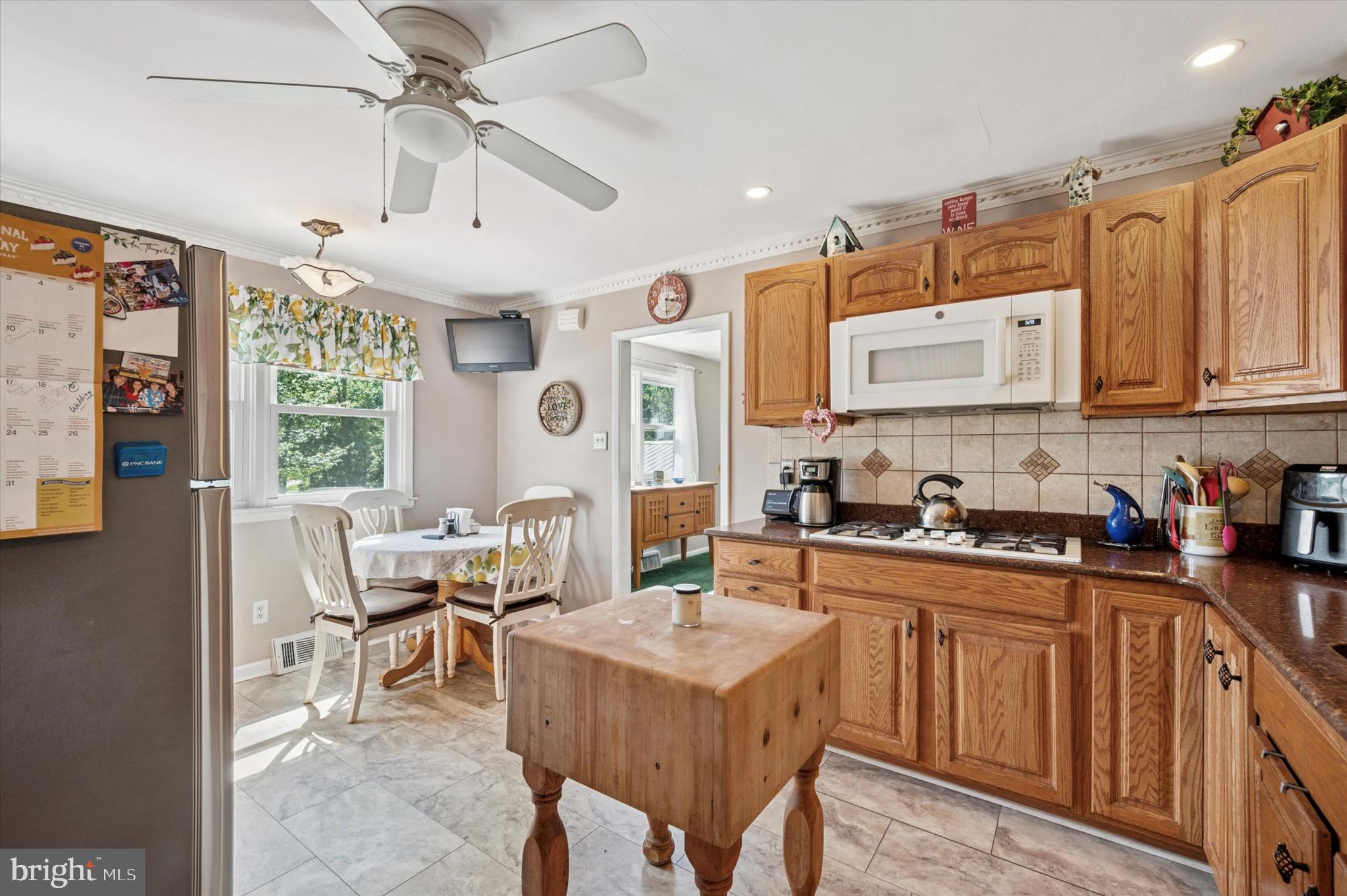 1007 Glen Road Wallingford, PA 19086 - Photo 20 of 50 a kitchen with stainless steel appliances granite countertop a stove a sink dishwasher and cabinets with wooden floor