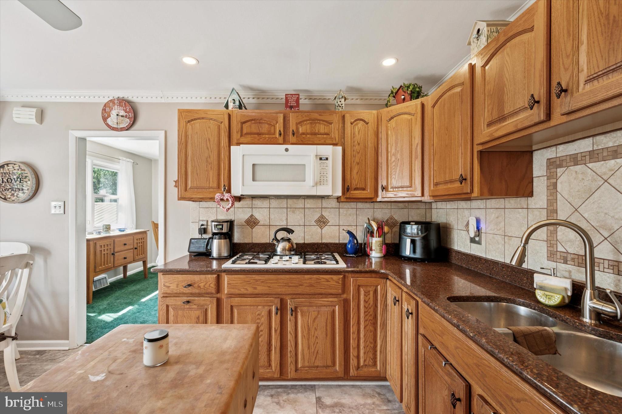 1007 Glen Road Wallingford, PA 19086 - Photo 21 of 50 a kitchen with stainless steel appliances granite countertop a sink stove and cabinets