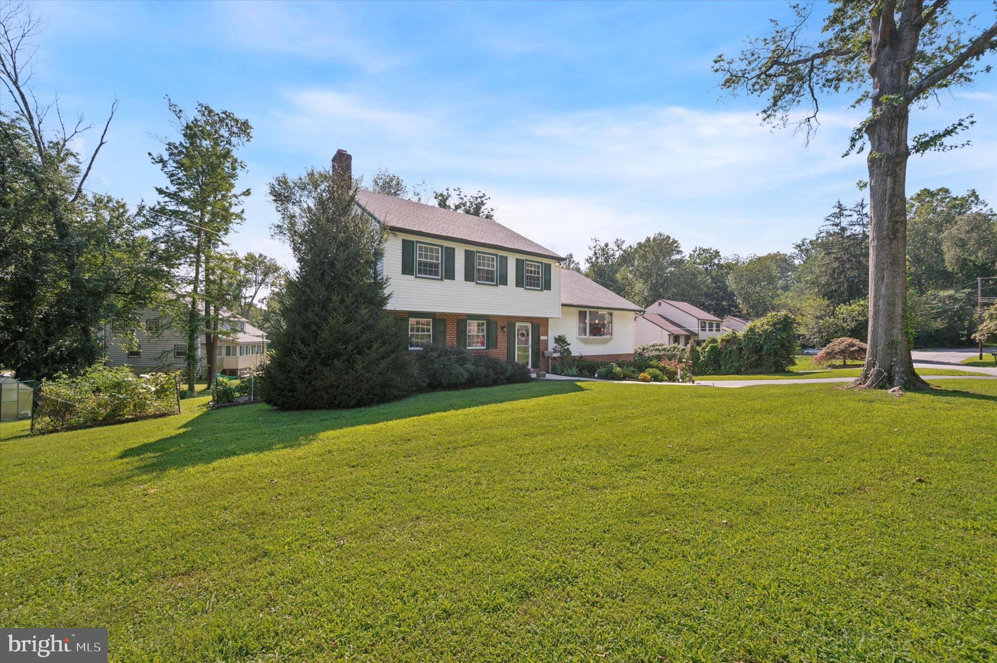 1007 Glen Road Wallingford, PA 19086 - Photo 3 of 50 a front view of a house with a garden and tree