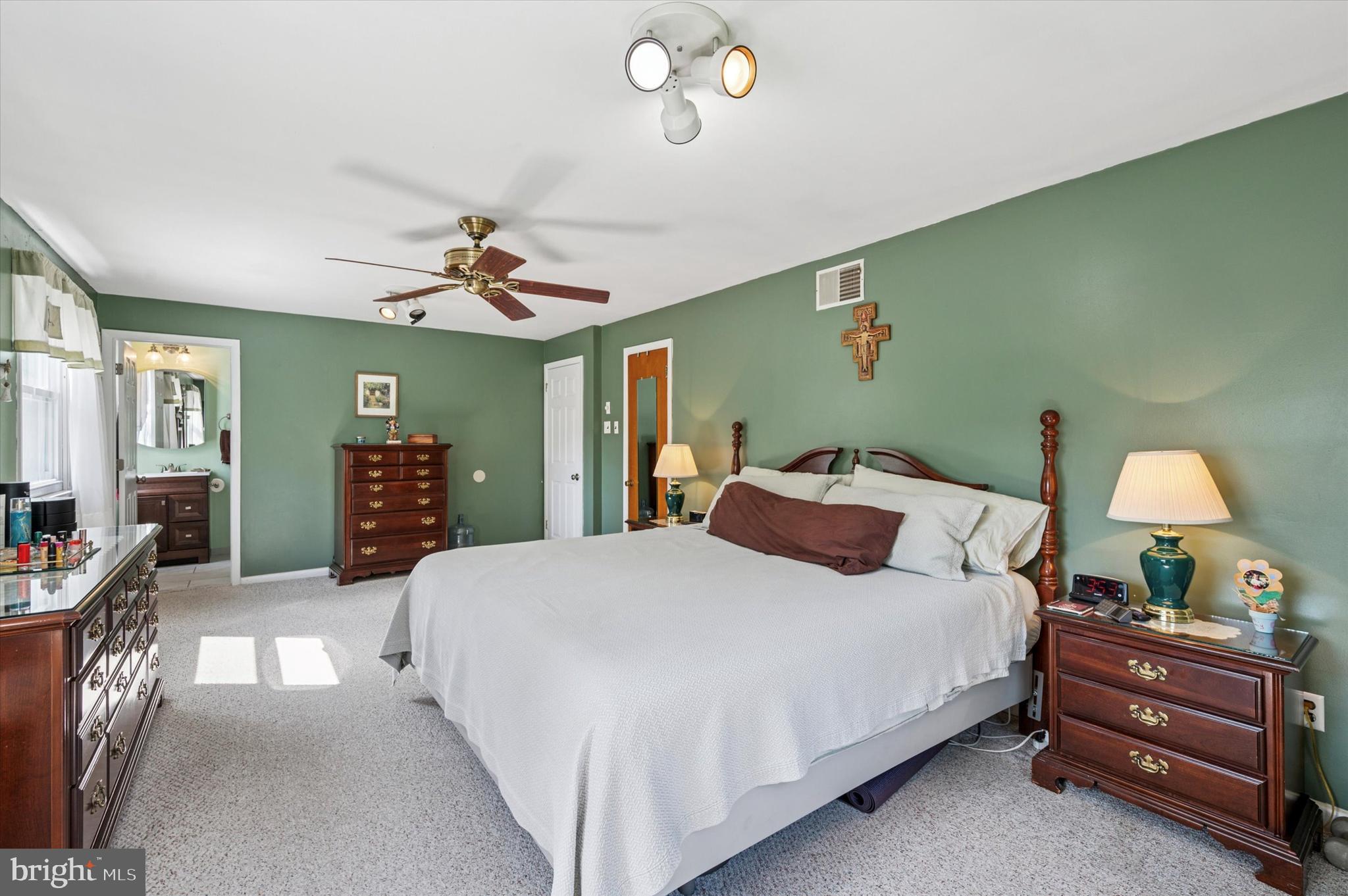 1007 Glen Road Wallingford, PA 19086 - Photo 33 of 50 a bedroom with a bed and a chandelier