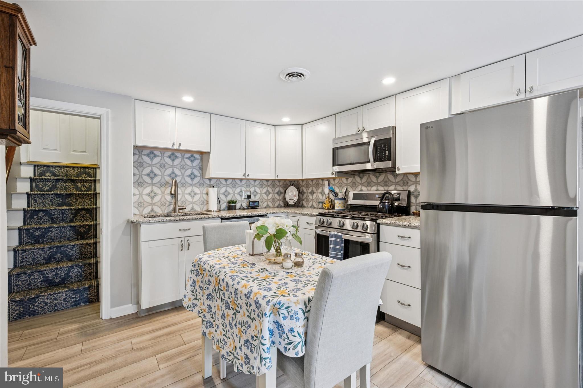 1007 Glen Road Wallingford, PA 19086 - Photo 36 of 50 a kitchen with stainless steel appliances a refrigerator stove microwave and cabinets
