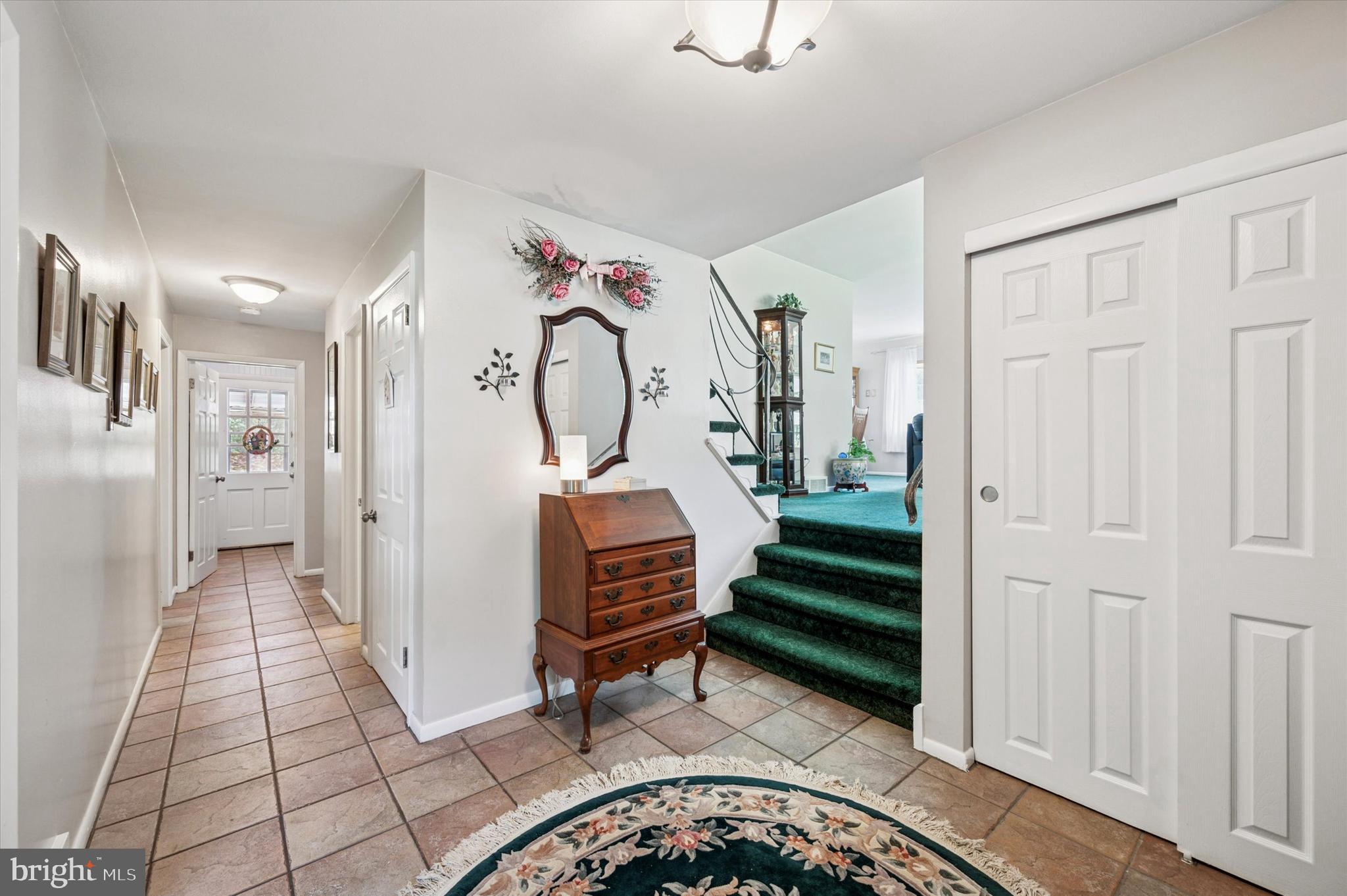 1007 Glen Road Wallingford, PA 19086 - Photo 4 of 50 a view of a hallway with entryway wooden floor and front door