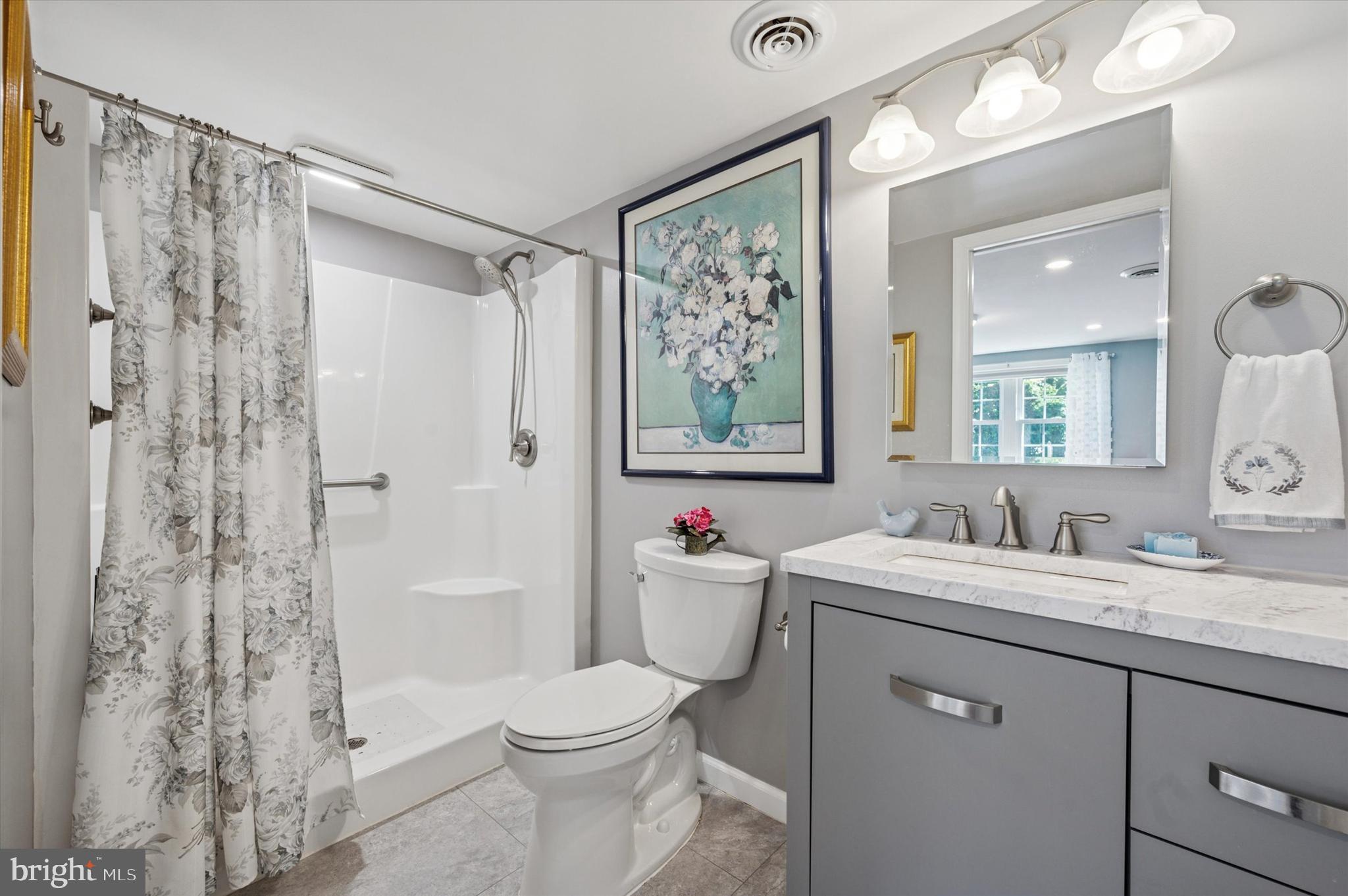 1007 Glen Road Wallingford, PA 19086 - Photo 43 of 50 a bathroom with a sink vanity mirror and toilet