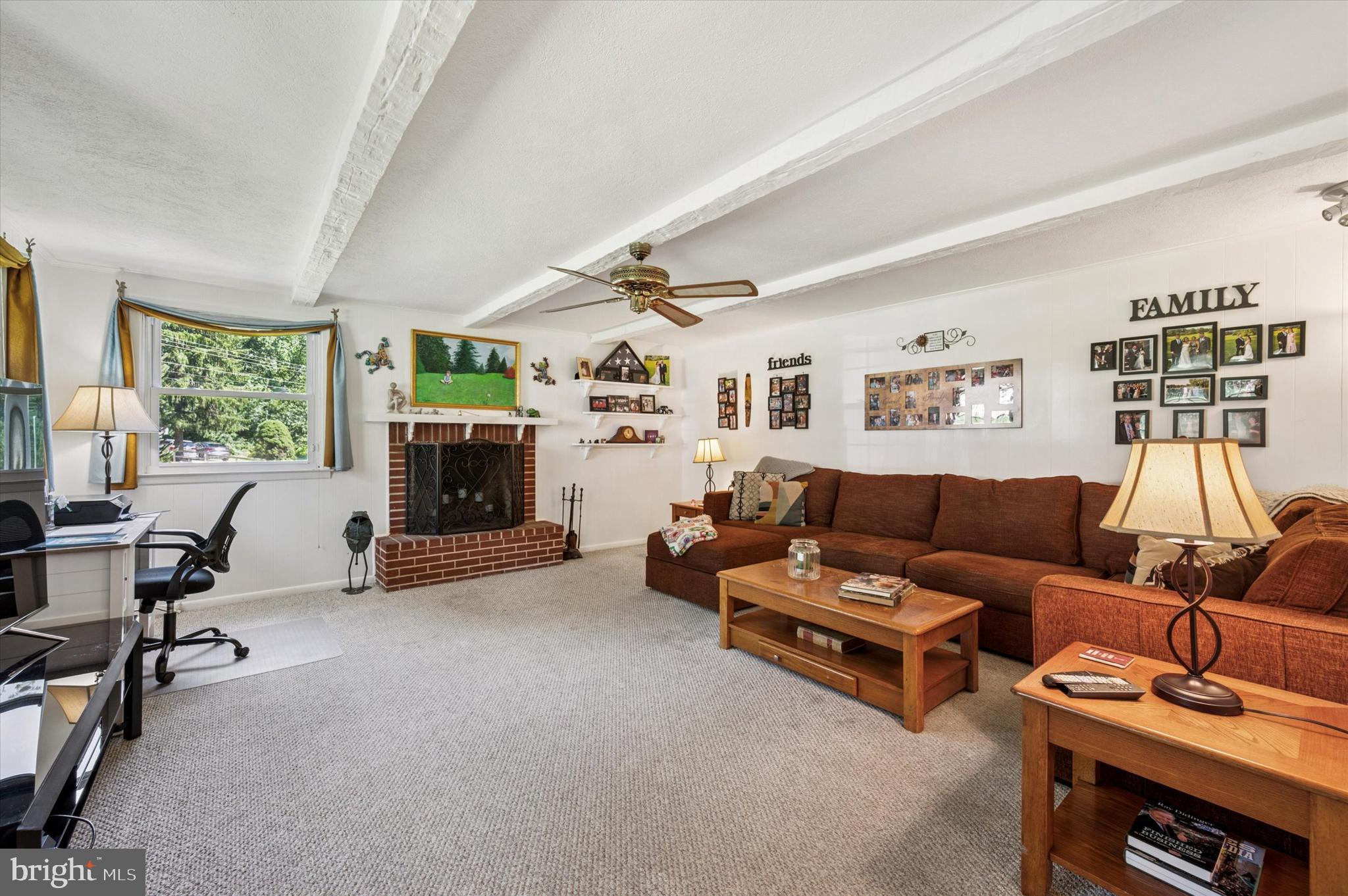 1007 Glen Road Wallingford, PA 19086 - Photo 6 of 50 a living room with furniture and a fireplace