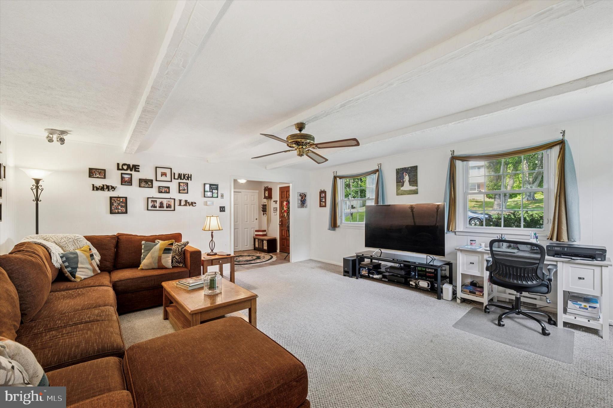 1007 Glen Road Wallingford, PA 19086 - Photo 7 of 50 a living room with furniture a ceiling fan and a flat screen tv